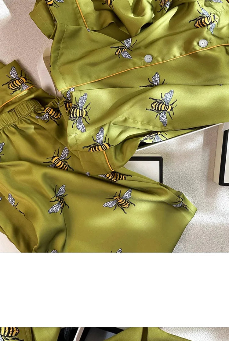 Green fabric with bee patterns on a white background