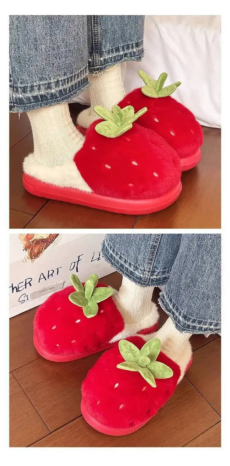 Red strawberry-shaped slippers worn with white socks on a wooden floor.